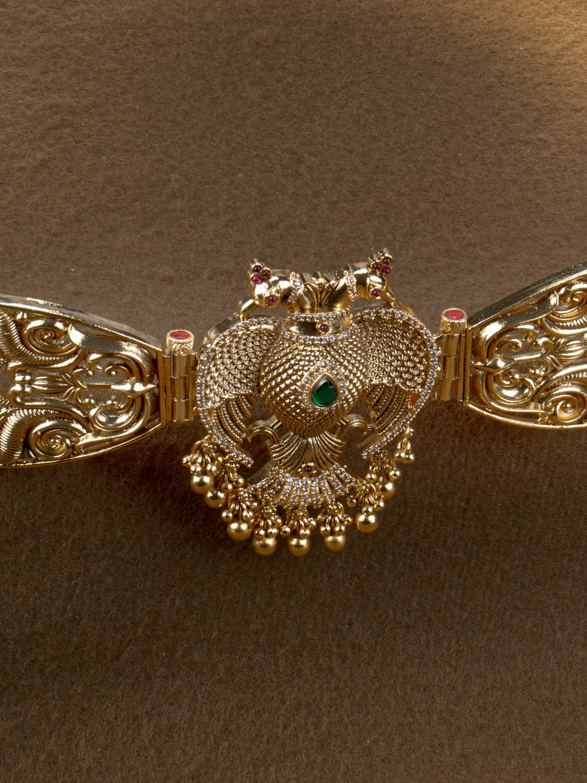 Mayura Hridaya Hip Belt - close-up of peacock centrepiece with stones and gold bead drops