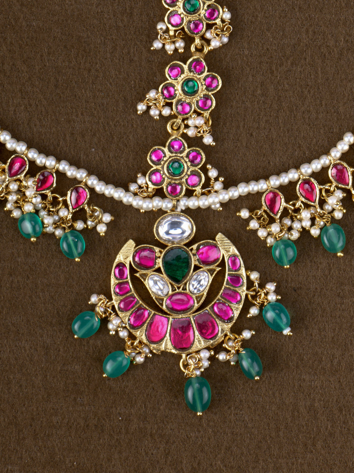 Chandrika Jadau Mathapatti - close-up of crescent jadau tikka with green bead drops